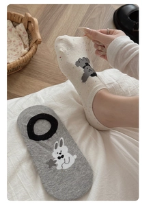 Close-up of thin cotton no-show socks with cartoon rabbit and puppy knit patterns