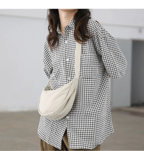Minimalist beige nylon crescent crossbody bag styled with casual daily outfit on a model