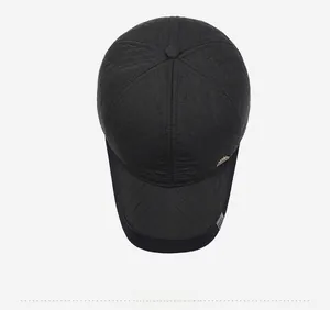 Detail of black quilted baseball cap for men featuring diamond stitching and metal logo