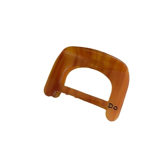 Minimalist amber tortoise shell acetate hair claw clip with cutout geometric D design