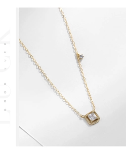 Macro shot of 925 silver gold square sugar cube pendant necklace with zircon detail
