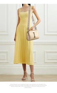 Detail of champagne gold crossbody bag with woven strap and metallic tassel puller