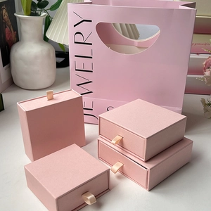 Elegant pink drawer-style jewelry box set with matching gift bag for necklaces and rings