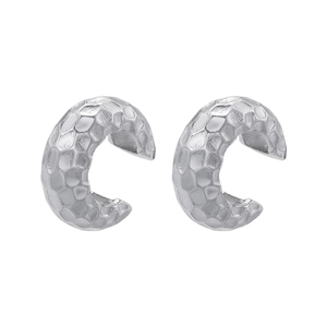 Detailed view of silver textured ear cuffs with hammered surface and open C-shape design
