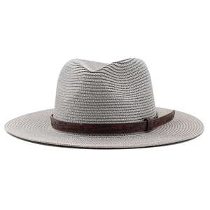 Close-up of grey woven straw cowboy hat with a brown embossed leather decorative band