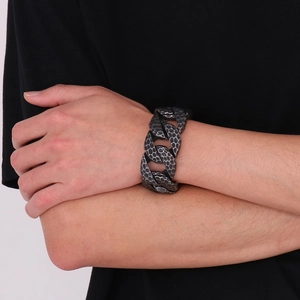 Detail of vintage industrial steel bracelet with hammered texture on male wrist