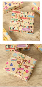 Detail of eco-friendly kraft paper gift wrap with colorful Happy Birthday patterns