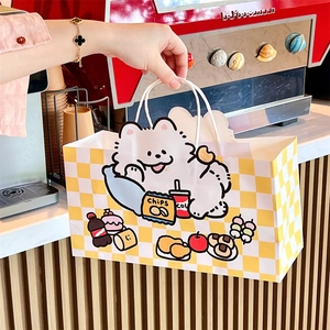 Detail of yellow checkered paper gift bag with cute cartoon dog and white rope handles