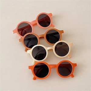 Detailed stack of round frame kids sunglasses in macaron matte earth tones