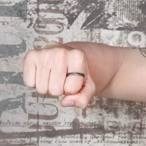 Minimalist titanium steel geometric rhombus ring with industrial finish shown on finger