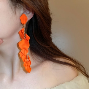 Detail of orange rose petal tassel clip-on earrings on model for an elegant look