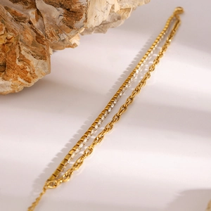 Double-layer gold stainless steel bracelet with a crystal tennis chain and oval links