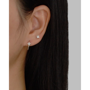 Detail shot of 925 silver four-leaf clover stud and hoop earrings with zircon stones