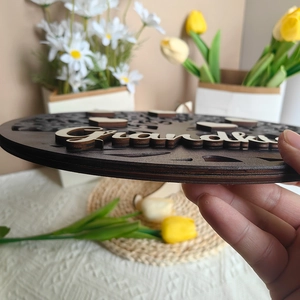 Wooden Mother's Day round Grandma sign with 3D heart tree carving held by hand