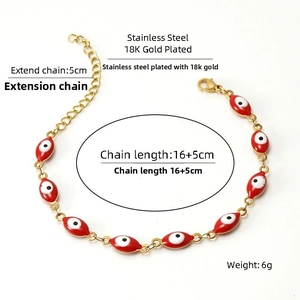 Detail of 18K gold plated stainless steel bracelet with red enamel evil eye charms