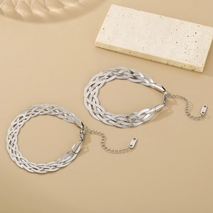 Flat lay of two silver-tone braided snake chain necklaces with lobster clasps