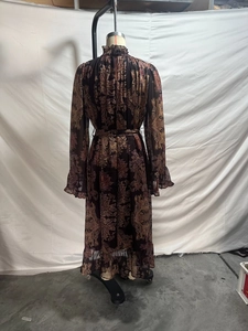 Detailed back view of a bohemian paisley chiffon maxi dress with ruffled trim and long sleeves