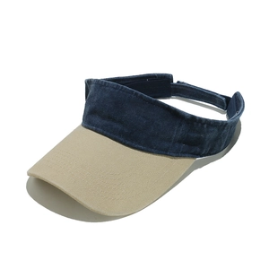 Detail of navy and beige visor hat showing durable canvas fabric and brim stitching