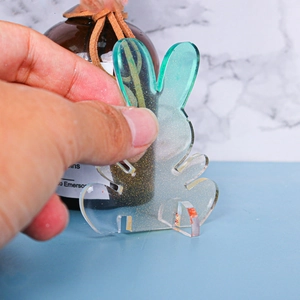 Detail of DIY Christmas rabbit resin craft with glitter and green gradient finish