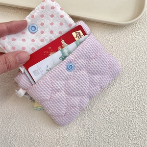 Handheld quilted pink striped card holder showing interior polka dot lining and card slots