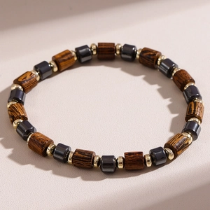 Men's beaded bracelet with wood grain texture, hematite stones, and gold-tone spacers