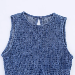 Close-up of smocked denim-effect fabric showing high-stretch texture and rear button detail