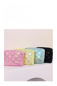 Detailed view of quilted metallic cosmetic bags in pink yellow blue and black colors