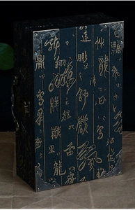 Macro detail of vintage blue book-style gift box with gold calligraphy and metal handle
