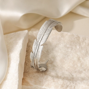 Elegant silver feather-shaped open cuff bracelet with detailed metallic texture