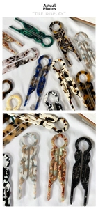 Detailed tile display of U-shaped hair pins with amber and marble texture acetate finish