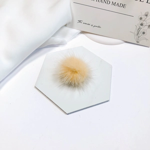 Close-up of soft fluffy mink fur pom pom in pale yellow for DIY hair accessory making