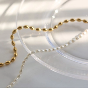 Mechanical splice necklace with rice pearls and 18K gold plated metal beads