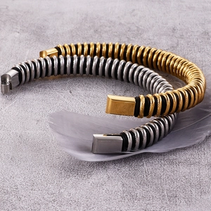 Detail of twisted metal wire bracelets with magnetic clasp in gold and silver finish