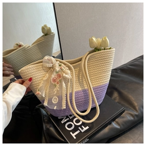 Detail of hand-woven tote bag in beige and purple with floral lace bow and tulips
