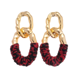Gold metal geometric oval earrings with red and black animal print fabric wrap details