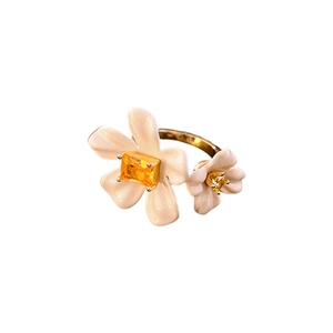 Gold plated open flower ring with white enamel petals and yellow zircon stones