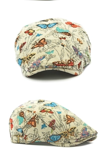 Detail view of ethnic jacquard beret showing butterfly patterns and antique metal buckle