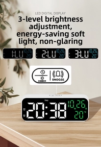 Detail of 9-inch LED mirror digital clock showing time, date and room temperature on wood