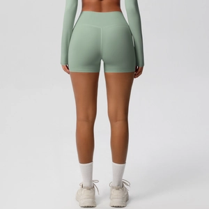 Detail of high waisted yoga shorts showing push-up seam and mint green brushed fabric