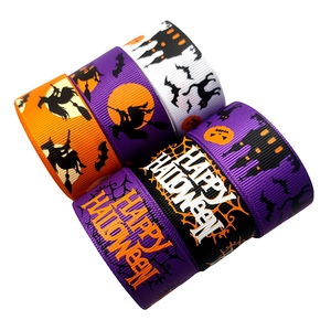 Detailed view of Halloween themed grosgrain ribbons with witch, pumpkin and bat patterns
