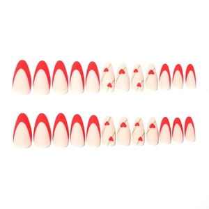 Faux ongles amande avec pointes françaises rouges et motifs de cœurs dorés pour la Saint