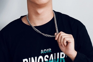 Mens hip hop chunky Cuban link chain in stainless steel worn by a model in black T-shirt