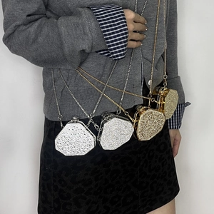 Detail of gold and silver hexagonal rhinestone evening bags with metal chains