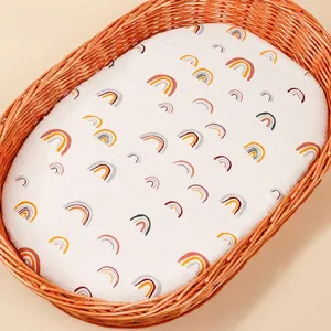 Detail of soft cotton fitted sheet with rainbow print for baby bassinet basket