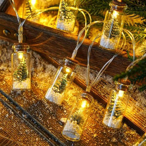 LED Christmas wishing bottle string lights with mini trees and snow inside glass jars