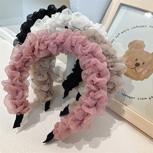 Detail showing sheer organza pleated headbands in pink, beige, white and black colors