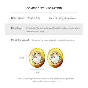 Macro detail of oval gold stud earrings with dimensions 1.4cm by 1.2cm and 5.2g weight