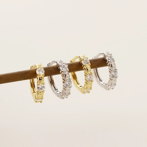 Close-up of geometric S925 silver hoop earrings with zircon in gold and silver finishes