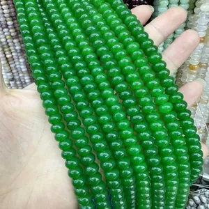 Close-up of polished green natural stone wheel beads for DIY jewelry making and bracelets