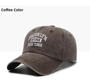 Close-up of white Brooklyn embroidery on coffee brown washed cotton baseball cap